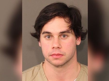 jesse's mugshot picture wearing a cream shirt 